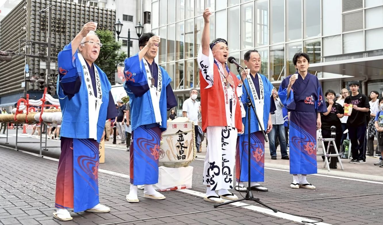 法被姿のメンバーがまつりで掛け声をかける様子